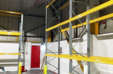 Pallet racking installed with upright protection allowing for safe access to fire exit